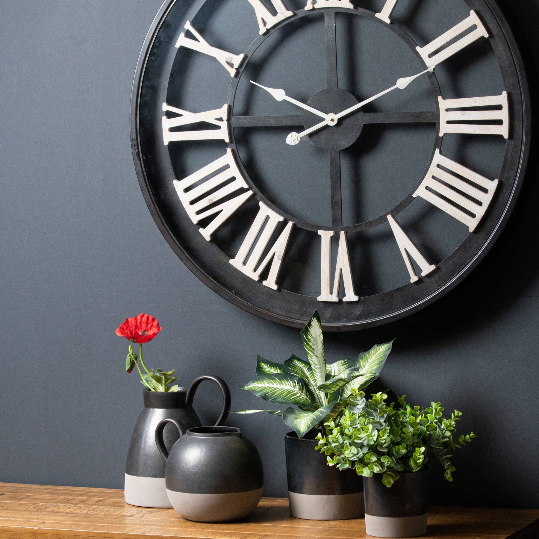 Black Framed Skeleton Clock With White Roman Numerals